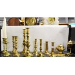 Five pairs of brass candlesticks and two other items.