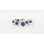An 18ct white gold ring set with mixed cut sapphires and diamonds, (P.5).