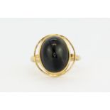 A 14ct yellow gold (stamped 14k) ring set with a cabochon cut black tiger's eye, (P).