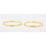 Two 22ct yellow gold (stamped 22c) bangles set with a brilliant cut diamond, Dia. 6.5cm, each