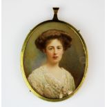 A framed Edwardian hand painted portrait miniature of a young woman, L. 9cm.