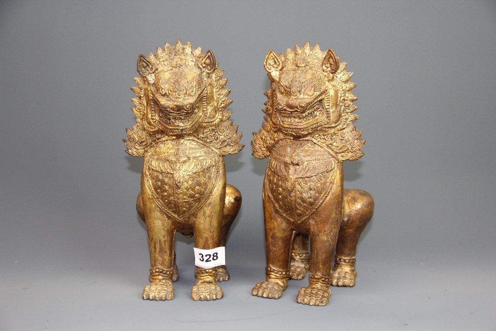 A pair of antique Burmese gilt bronze lion figures, H. 27cm.