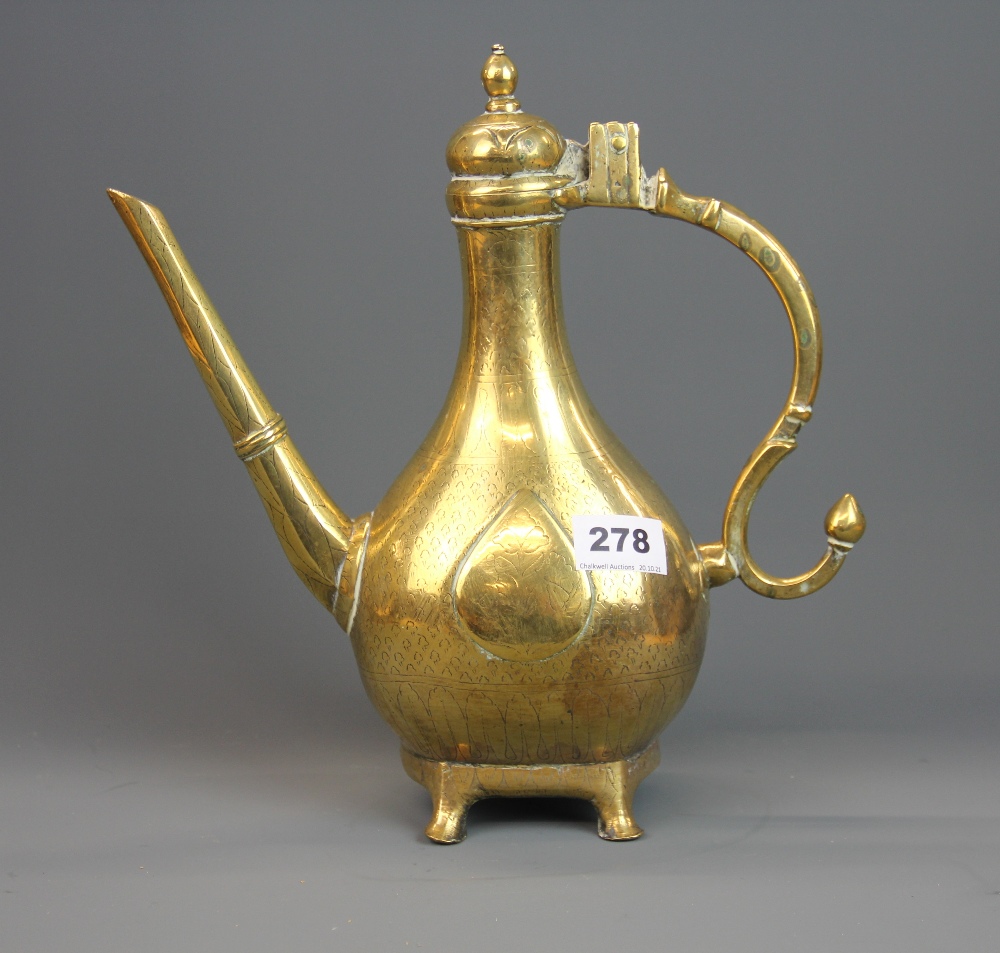 An early Indian polished bronze jug with engraved decoration, H. 30cm.