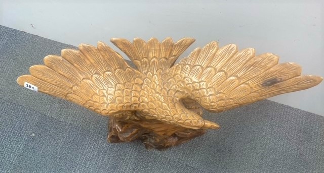 A large carved wooden figure of an eagle on a rock, H. 60cm. Wing span 78cm. - Image 3 of 3