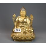 A Tibetan gilt and bronze painted figure of a seated Buddhist Lama. H.20cm.