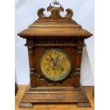 A 19th century carved oak striking mantle clock , H. 43cm.