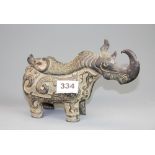 A Chinese Archaic form bronze model of a rhino with removable lid as a censer , L. 22cm. H. 15cm.