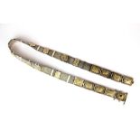 A lovely 19th Century Indian white metal and gilt panel (tested silver) belt, W. 2.5cm. L. 75cm.