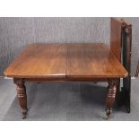 A Victorian oak extending dining table with two leaves. Unextended 133 x 117 x 73cm.