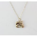A 9ct yellow gold chain with a 9ct horse shaped pendant, L. 41cm.
