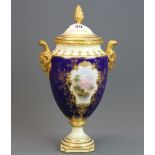 A fine hand painted Coalport porcelain urn and cover with goat head handles , H. 30.5cm.