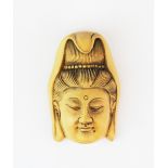 A small signed carved fruitwood netsuke of the goddess Guanyin, H. 5cm.