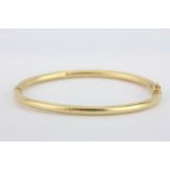 A 14ct yellow gold (stamped 14k) bangle, Dia. 7cm.