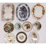 A quantity of meat plates and other decorative wall plates.