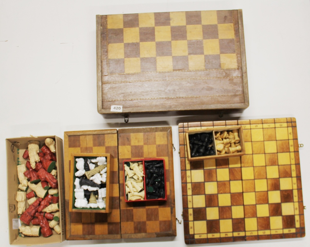 A group of chess sets and chess boards.