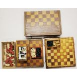 A group of chess sets and chess boards.