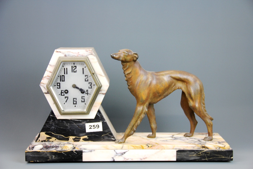 An Art Deco bronzed spelter and marble mantle clock, L. 47cm. H. 26cm.
