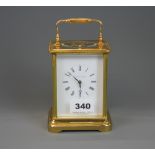 A gilt brass striking carriage clock by Mathew Norman, H. 18cm. Appears to be in working order.