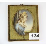 A framed hand painted portrait miniature on ivory of a young woman identified on the reverse as