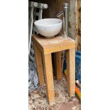 A freestanding wash basin and tap, H. 105cm.