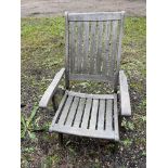 Eight folding teak garden chairs.