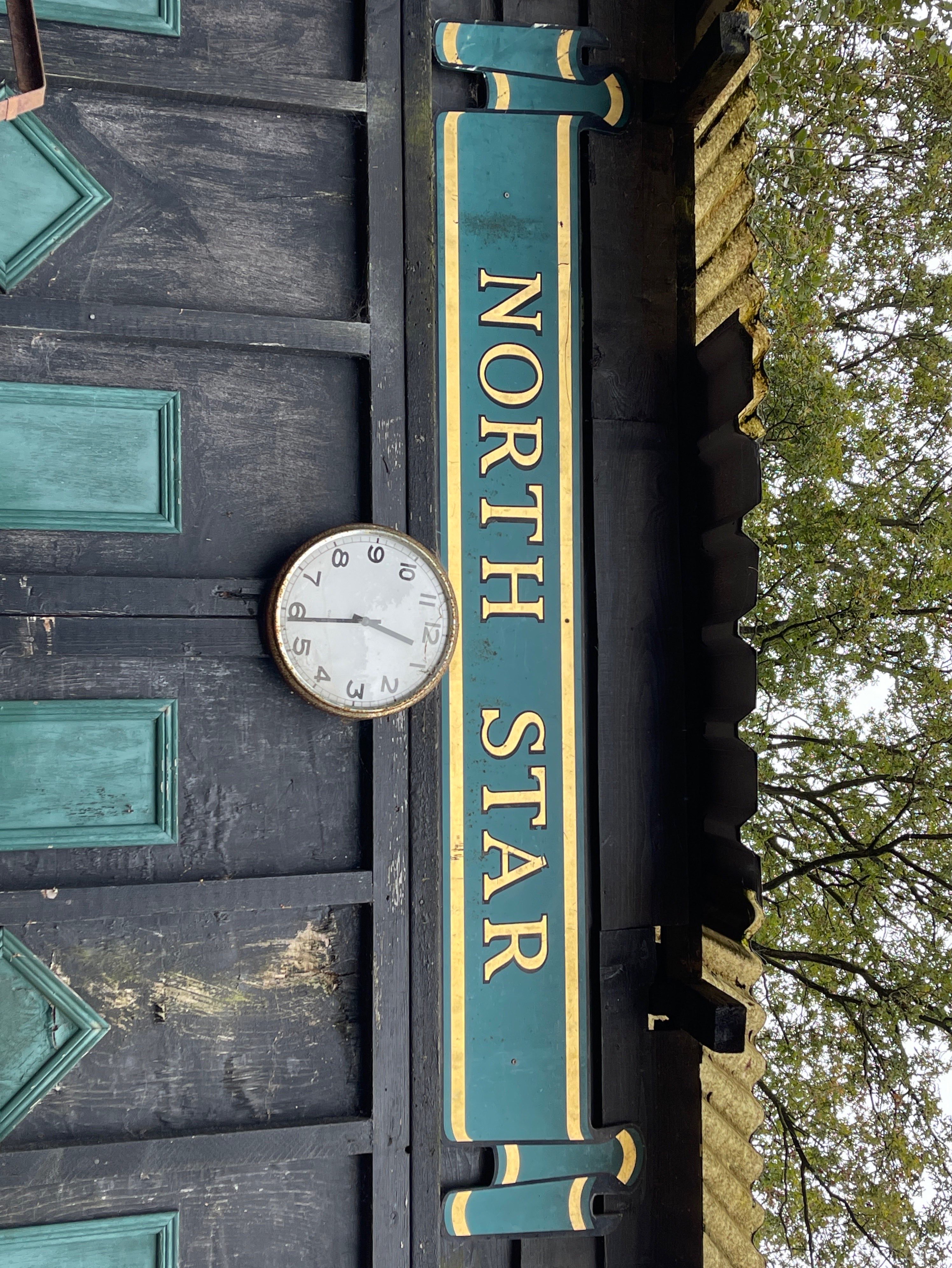 A handpainted wooden North Star sign.