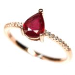 A 925 silver rose gold gilt ring set with a pear cut ruby and white stone set shoulders, (P.5).