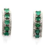 A pair of 925 silver earrings set with round cut emeralds and white stones, L. 2cm.