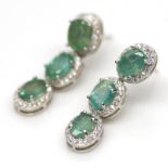 A pair of 925 silver drop earrings set with oval cut emeralds and white stones, L. 3cm.