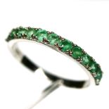 A 925 silver emerald set half eternity ring, (P).