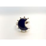 A 925 silver ring set with three cabochon cut opals, (P).