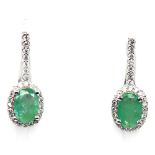 A pair of 925 silver earrings set with oval cut emeralds and white stones, L. 2cm.