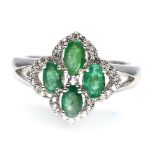 A matching 925 silver ring set with oval cut emeralds and white stones, (M).