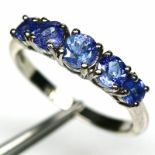 A 925 silver ring set with graduated tanzanites, (P).