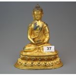 A Tibetan gilt bronze figure of a seated Buddha, H. 31cm.