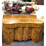 An Art Deco walnut veneered dressing table, W. 128.5cm.