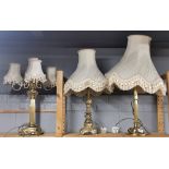 Three large gilt metal table lamps and shades.