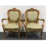 A pair of upholstered gilt carved wood 19th century throne style arm chairs. H. 110cm.