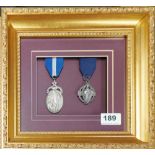 Two gilt framed Masonic medals, frame size 28 x 25cm.