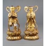 A pair of superb large Tibetan gilt bronze figures of Buddhist angels, H. 46cm.