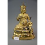 A Tibetan gilt bronze figure of a seated Buddhist deity, H. 26cm.