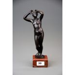 A 19th century classical bronze figure of a female nude on a red marble base, H. 29cm.