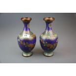 A pair of mid 20th century Chinese cloisonne on copper vases, H. 24cm (minor dent to one vase).