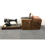 A cased singer sewing machine and workbox.