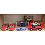 A group of mixed large scale die cast model vehicles.
