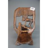 An African carved hardwood miniature stool, H. 24cm.