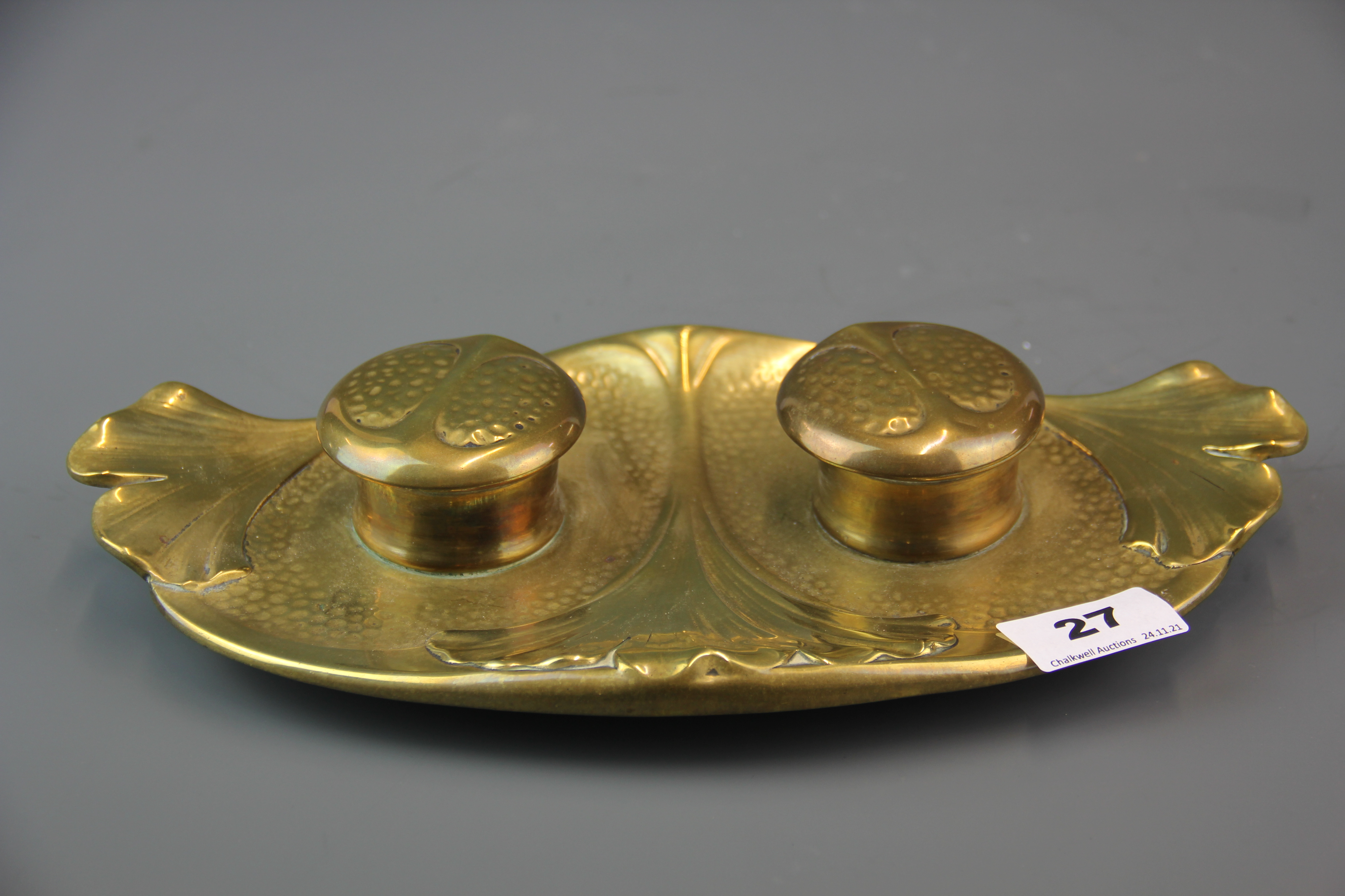 An Art Nouveau bronze inkwell stamped Geschutzt, L. 30cm. glass inkwells A/F.