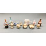 A group of oriental porcelain items, including a Chinese birdfeeder and a small Canton enamelled