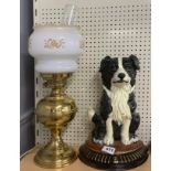 A painted cast iron door stop and an oil lamp style table lamp.