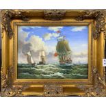 A gilt framed oil on board of sailing ships, frame size 56 x 46cm.